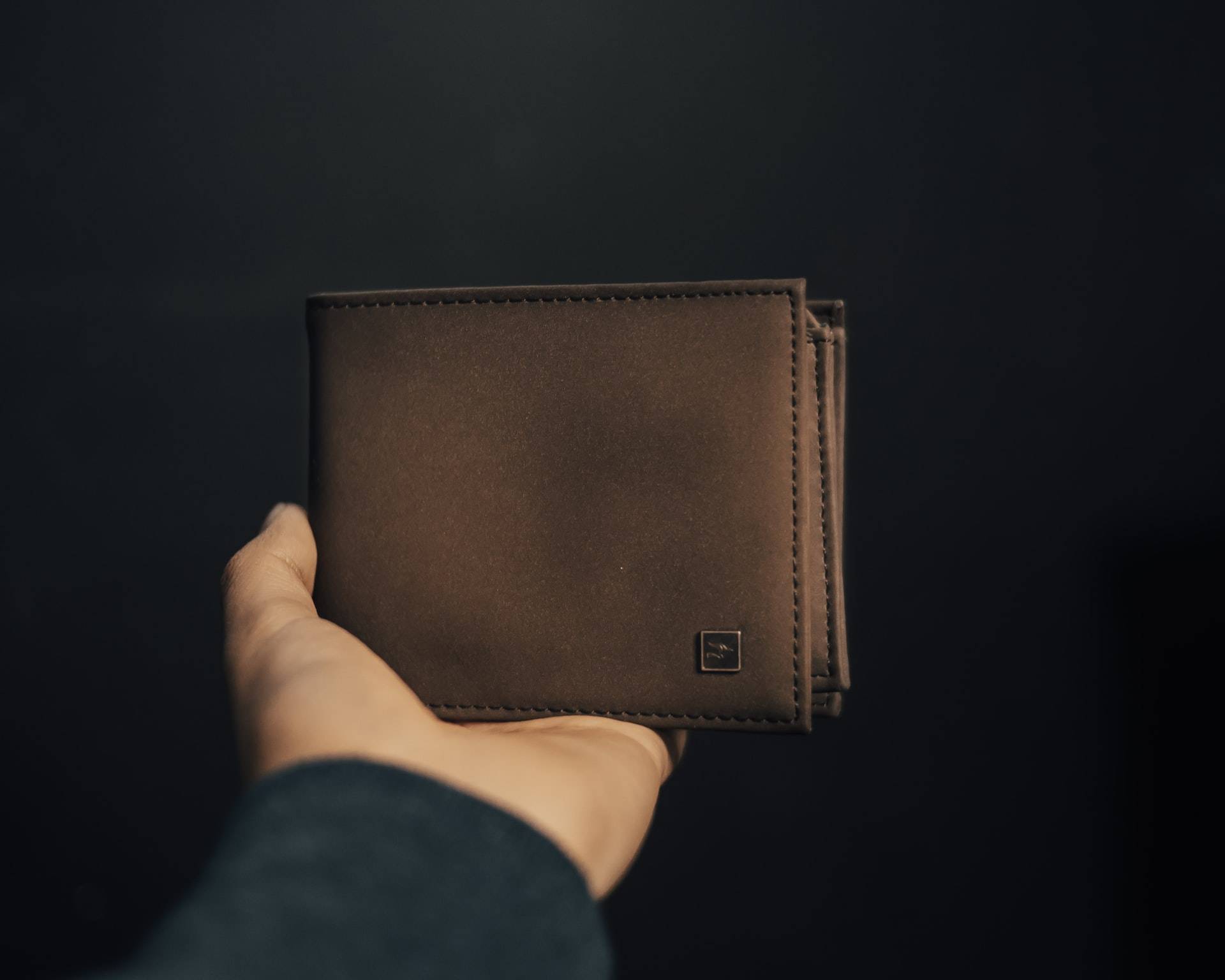 Man holding a leather wallet - Darren Yaw released