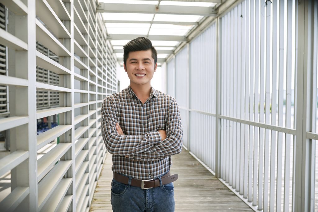 Young Asian businessman with crossed arms